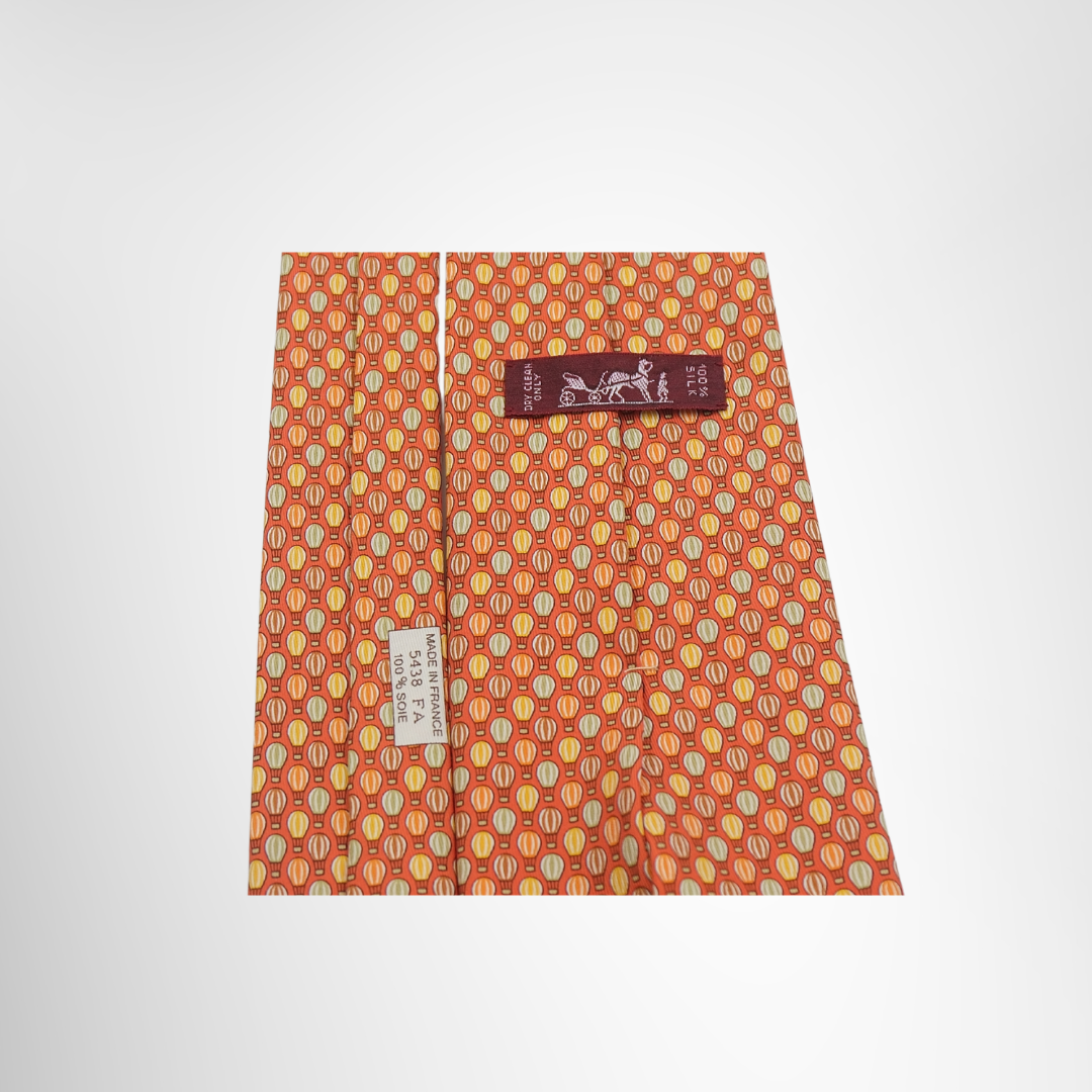 Hermes Preowned Luxury Orange Necktie Close Up View With Brand Tag